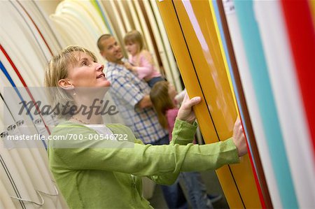 Family Looking at Surfborads in Store