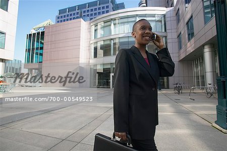 Businesswoman with Celluar Phone And Briefcase