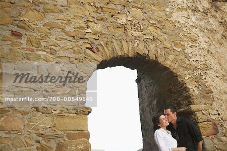 Couple in Archway Castiglione della Pescaia, Tuscany, Italy