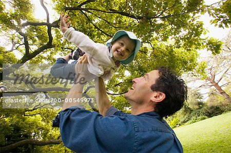Father Lifting Daughter into Air
