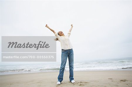 Woman Cheering on Beach