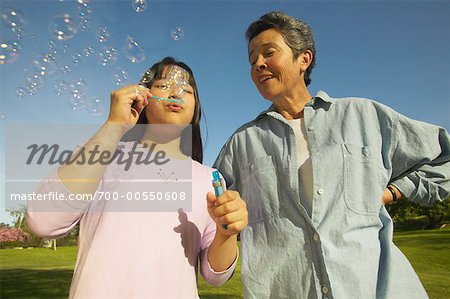 Grandmother and Granddaughter Blowing Bubbles