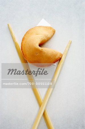 Chopsticks holding Fortune Cookie