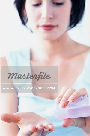 Woman Pouring Lotion Into Hand