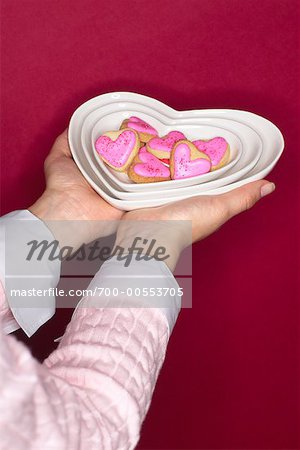 Woman's Hands Holding Bowl of Heart Shaped Cookies