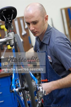 Man Fixing Bike in Shop