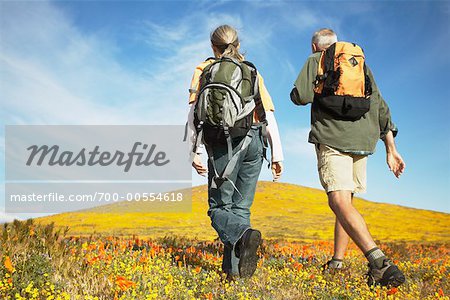 Couple Hiking Through Wildflowers