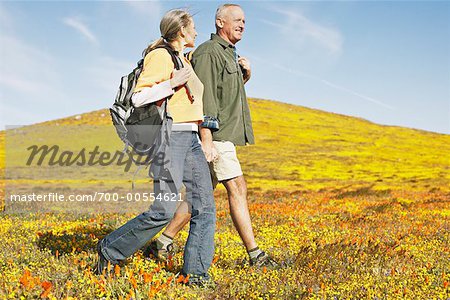 Couple Hiking Through Wildflowers