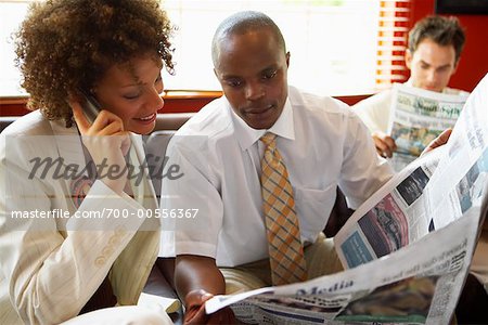 Business People Reading Newspaper