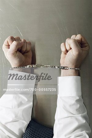 Businessman's Hands Handcuffed