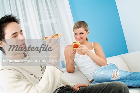 Jeune Couple manger Pizza