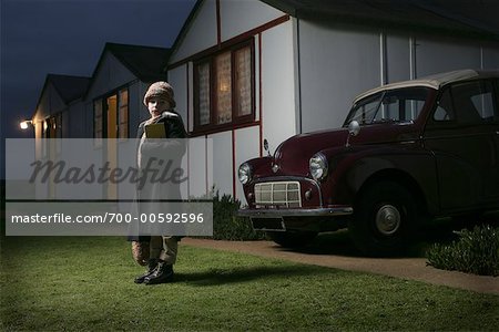 Girl Standing in Front of House at Night