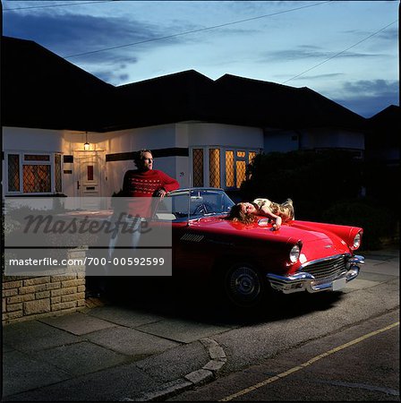 Couple in Driveway with Car