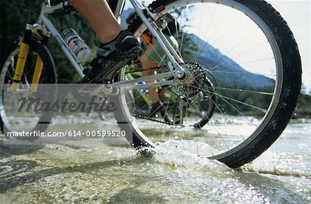 People cycling across a stream