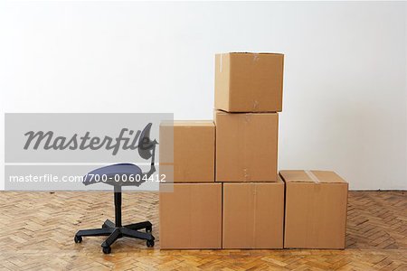 Boîtes en carton et chaise de bureau