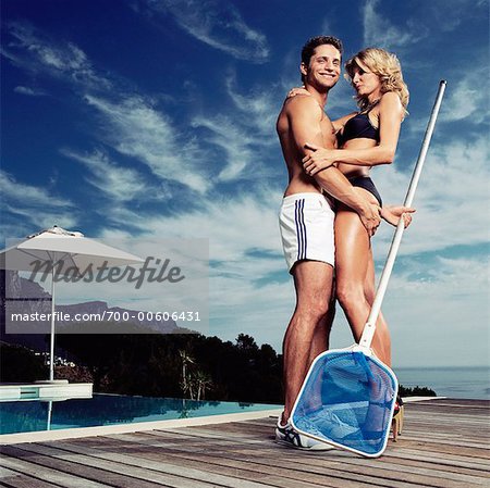 Pool Boy Embracing Woman in Bikini
