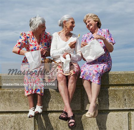 Women Eating Lunch on Brick Wall