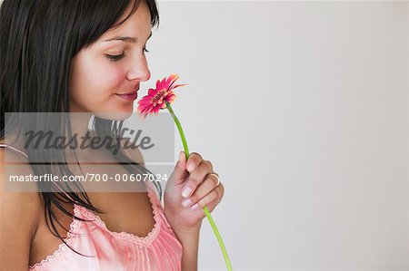 Portrait of Woman Smelling Flower