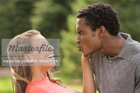 Man Trying to Kiss Woman