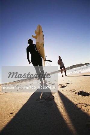 Surfer and Jogger on the Beach, Bondi Beach, Sydney, New South Wales, Australia