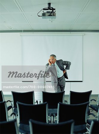 Businessman in Empty Boardroom