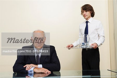 Assistant Holding Tray, Standing beside Boss