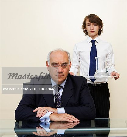 Assistant Holding Tray, Standing behind Boss