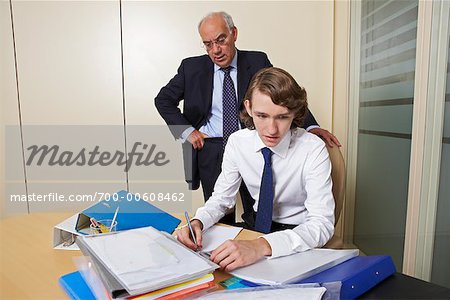 Boss Watching Young Businessman Working