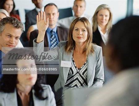 Woman Raising her Hand at Conference