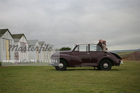 Couple Sitting on Car