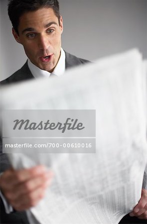 Businessman Reading Financial Page of Newspaper