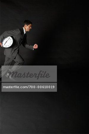 Businessman Running with Clock