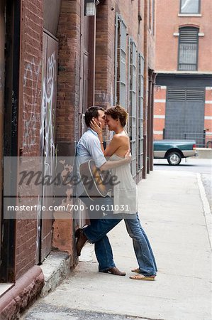 Couple Kissing on Sidewalk