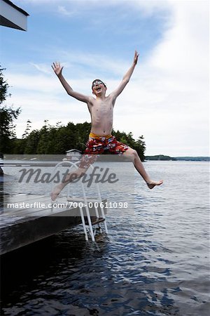 Boy Jumping into Lake Rosseau, Muskoka, Ontario, Canada