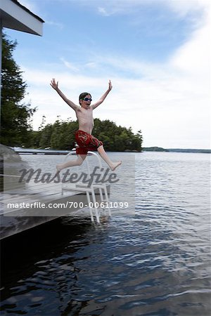 Jeune garçon plongeant dans le lac Rosseau, Muskoka, Ontario, Canada