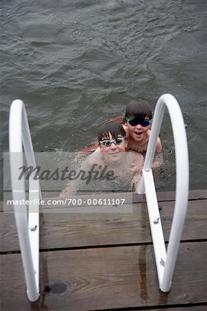 Two Brothers Swimming in Lake