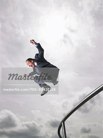 Businessman Jumping Over Railing