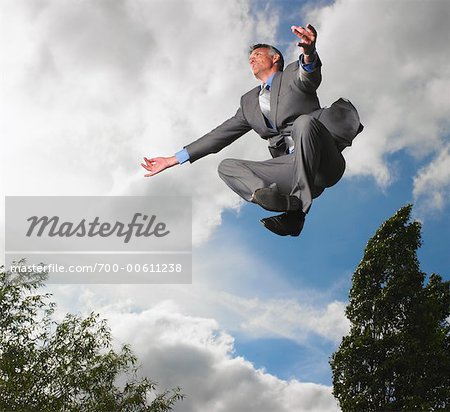 Businessman Meditating While Levitating