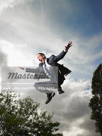 Businessman Jumping in Air