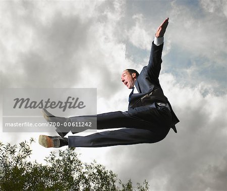 Businessman Jumping in Air