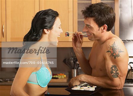 Man Feeding Woman Sushi