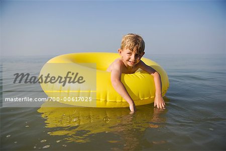 Boy Playing with Inner Tube