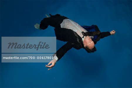 Businessman Floating in Swimming Pool