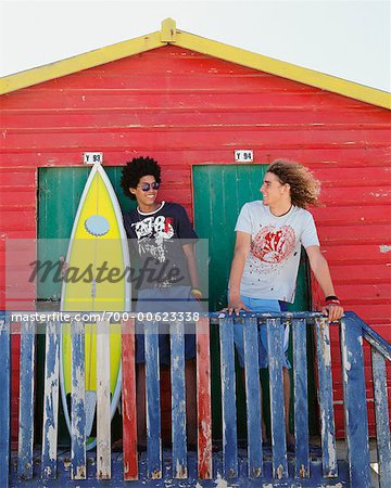 Friends by Beach Hut with Surfboard