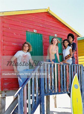 Friends by Beach Hut with Surfboard