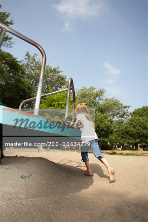 Girl Playing on Merry-Go-Round