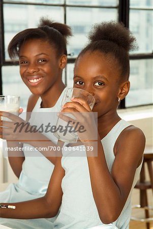 Portrait of Sisters Drinking Milk
