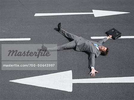 Businessman Lying on Road