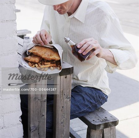 Man Eating Fish and Chips