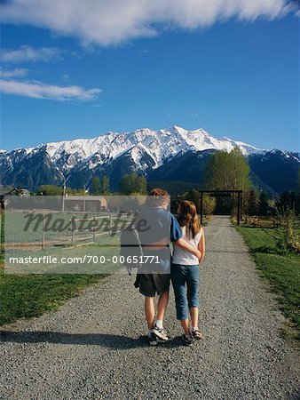 Teenage Couple Walking on Gravel Road